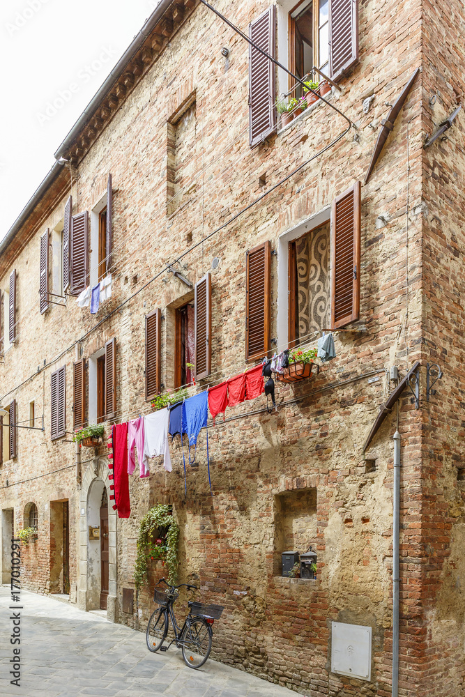 Italian alleyway with hanging laundry and a parked bicycle