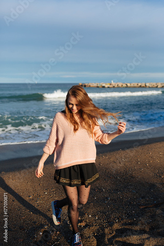 Happy woman enjoy the beach at sunset photo