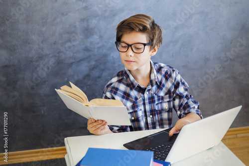 Teen boy reading book and u...