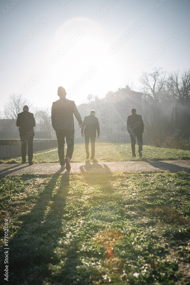 A group of four urban gentlemen in suits A group of four urban gentlemen in suits