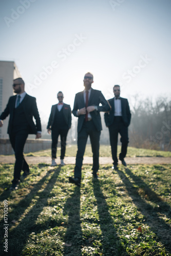 A group of four urban gentlemen in suits photo