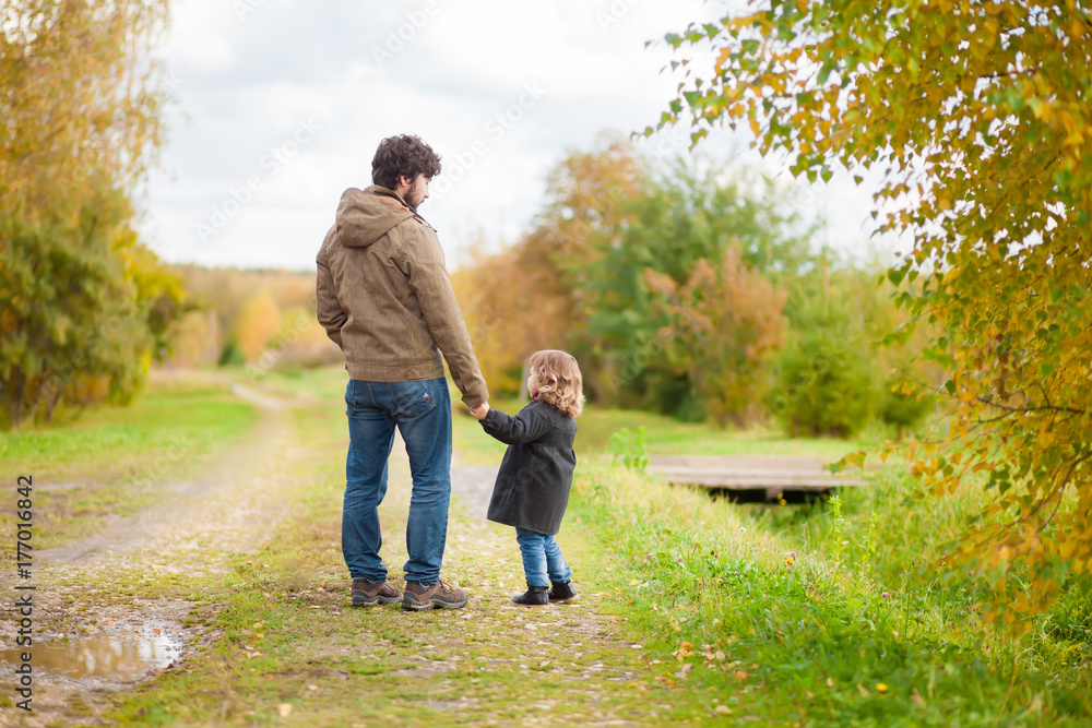 Father and daughter walking together, autumn day Father and daughter walking together, autumn day