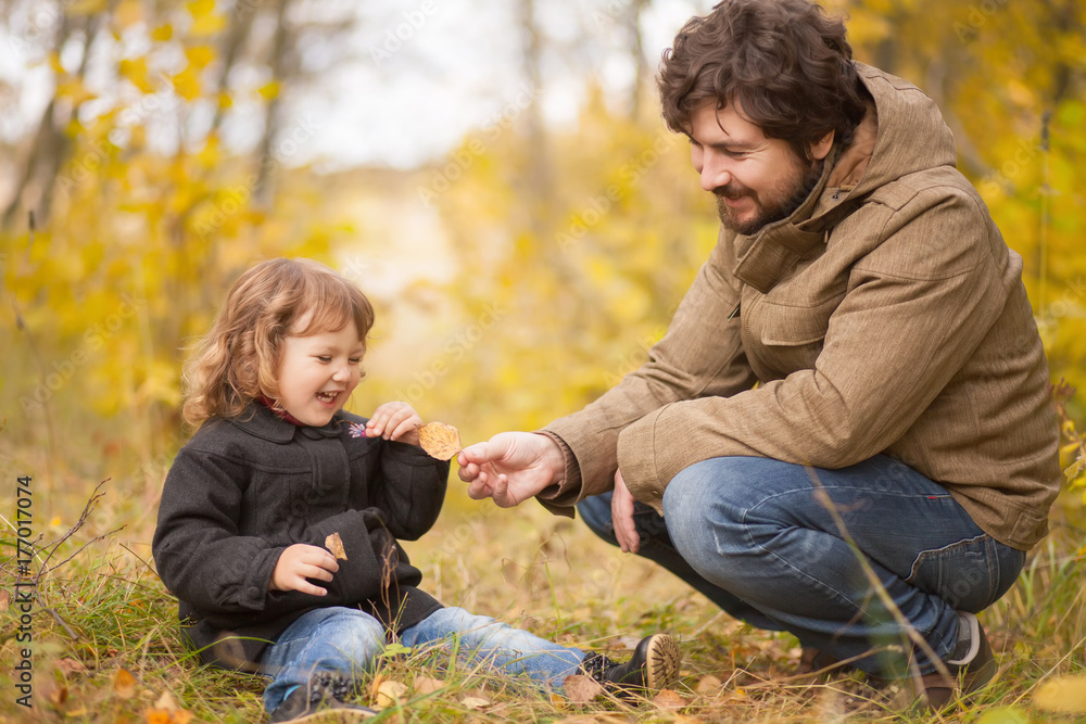 Father and his little daughter together in the forest Father and his little daughter together in the forest