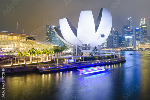 Corolla of the ArtScience Museum and shopping centre mirrored in water, facing the Marina Bay and the Business District in Singapore.