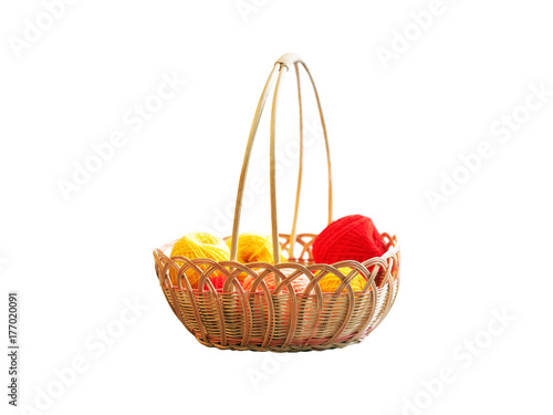 Wicker basket with needlework. Basket with colorful skeins of yarn, tangles isolated on white background © ANGHI