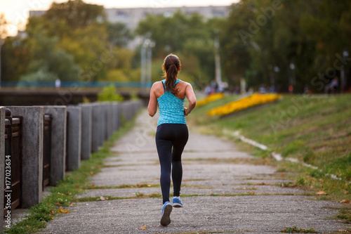 Photography Young beautiful woman running in park in the morning