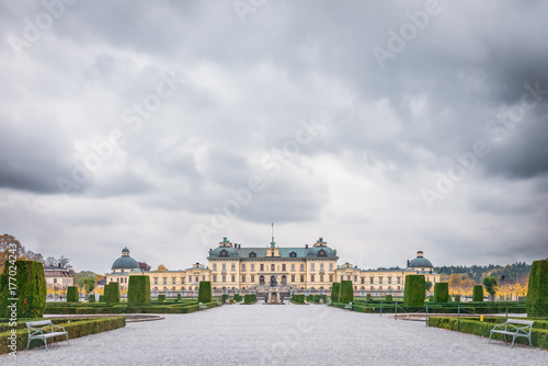 View over Drottningholm Palace and park on a cloudy autumn day. Home residence of Swedish royal family. Famous landmark and tourist destination in Stockholm, Sweden