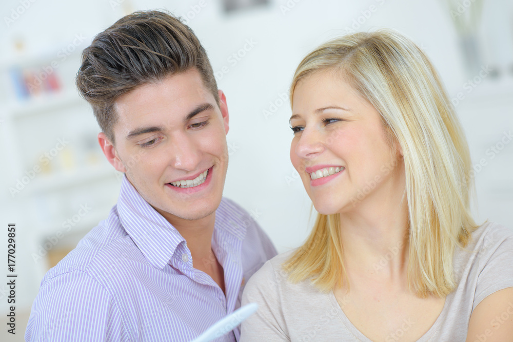 lovers looking at a pregnancy test at home lovers looking at a pregnancy test at home
