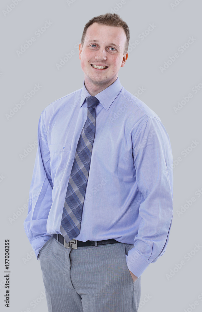 Young manager in suit is smiling isolated on gray background Young manager in suit is smiling isolated on gray background