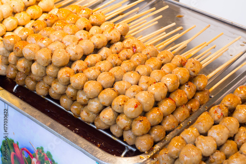 Fishball and meatball and sausage with stick serve on street food photo