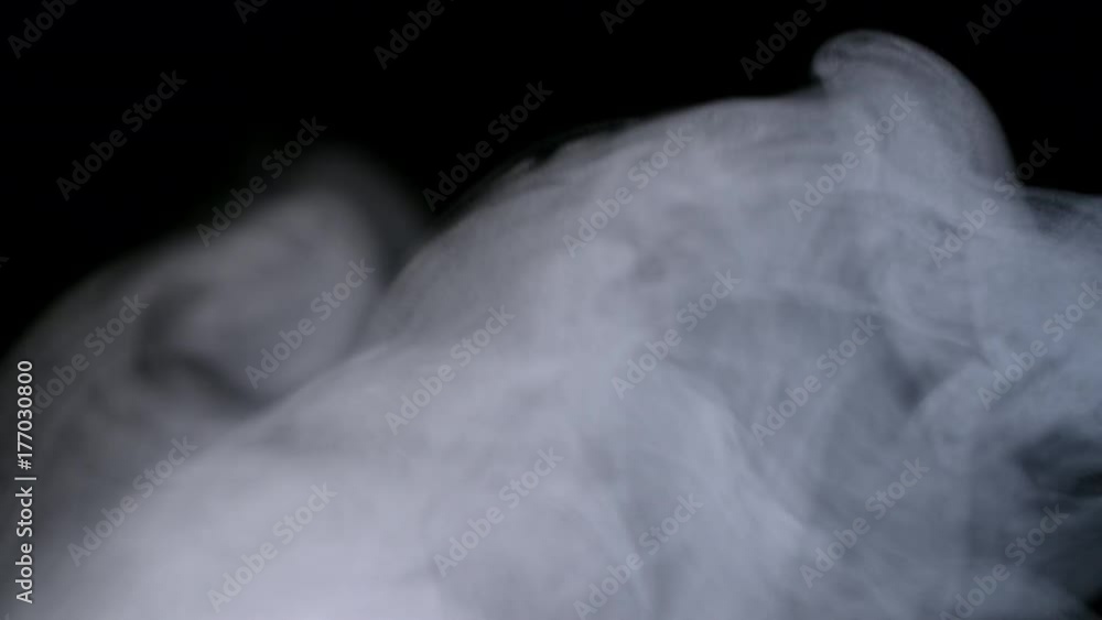 Smoky fog clouds over a black background. You can add this footage to your video project by dropping it in and changing its blending mode to Screen or Add Smoky fog clouds over a black background. You can add this footage to your video project by dropping it in and changing its blending mode to Screen or Add