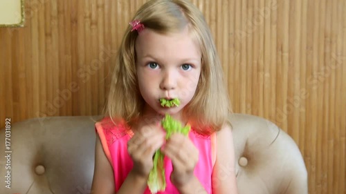 girl eats vegetables and herbs