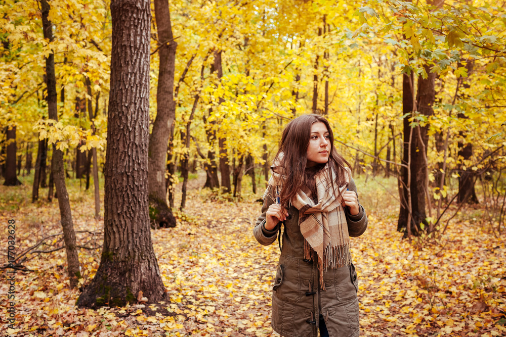 Tourist walking through the autumn forest Tourist walking through the autumn forest