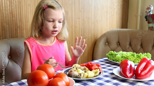girl eats vegetables and herbs