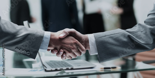 business partners shake hands after a meeting on the background  photo