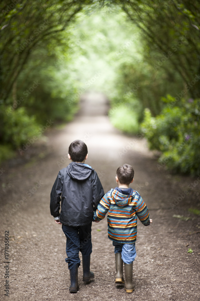 two anonymous boys from behind in the forest two anonymous boys from behind in the forest