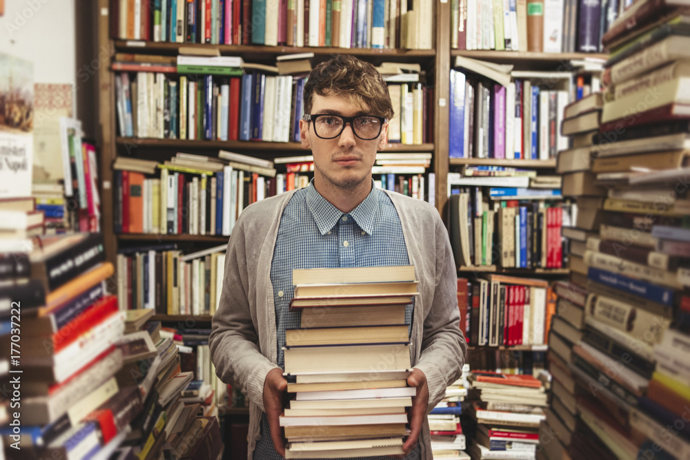 © pozzi/Stocksy - Young man in a book store