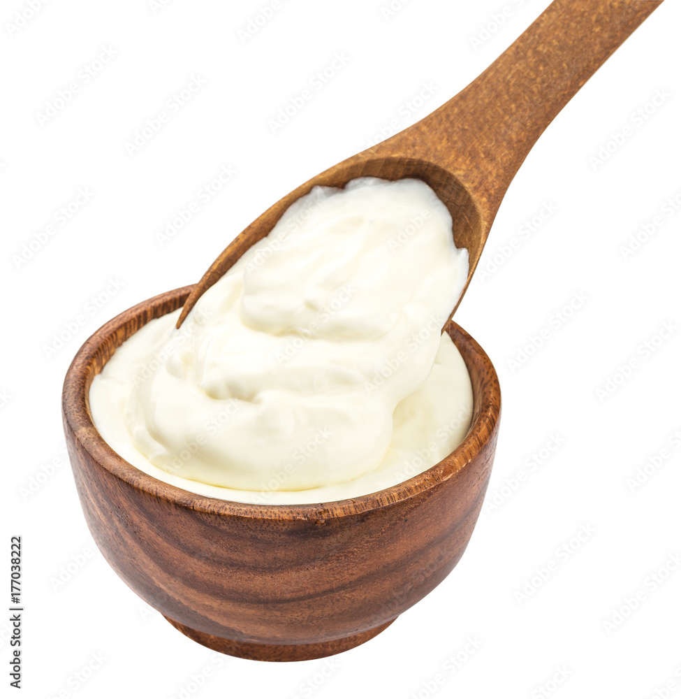 Sour cream in wooden spoon isolated on white background Sour cream in wooden spoon isolated on white background