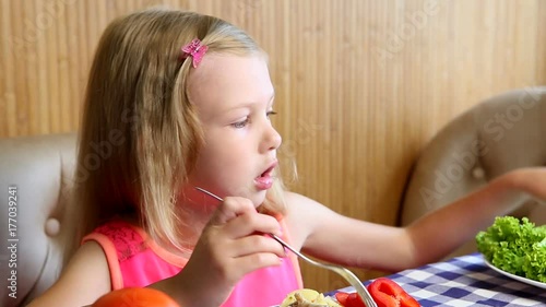 girl eats vegetables and herbs