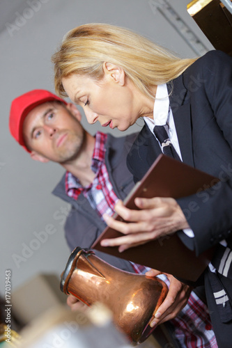 female mangaer talking to worker in warehouse photo