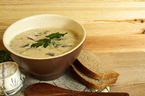 Mushroom soup with cream. Mushroom soup on an old wooden background. Selective focus. Horizontal.