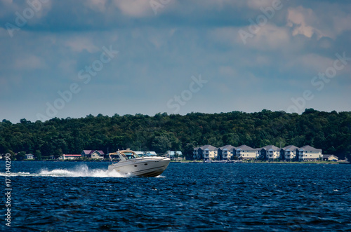 Power Boat speeding along the Upper New York State shoreline © GrB