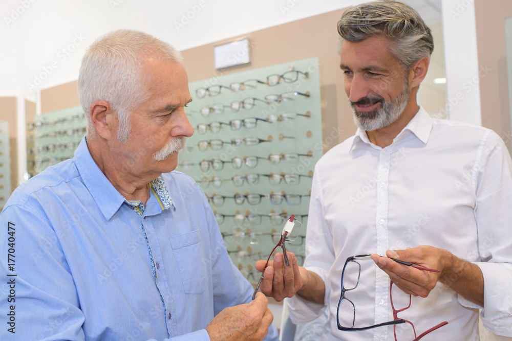senior man trying new eyeglasses on senior man trying new eyeglasses on