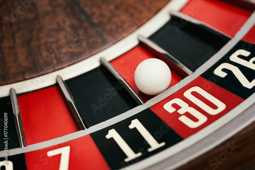 Casino: Ball Rests In 30 Slot On Roulette Wheel photo