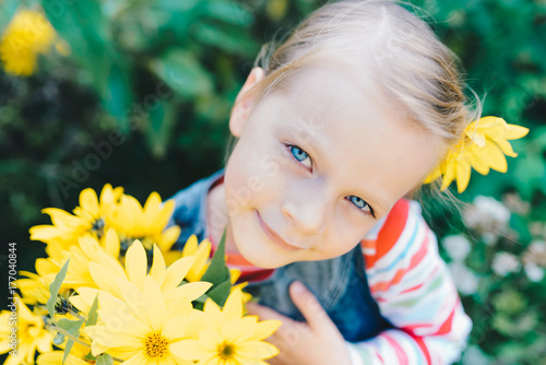 Wallpaper Mural Little girl with a bouquet of yellow wildflowers in a meadow Torontodigital.ca