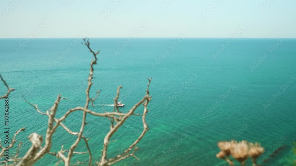 Top view from mountain of yacht sailing in sea Top view from mountain of yacht sailing in sea