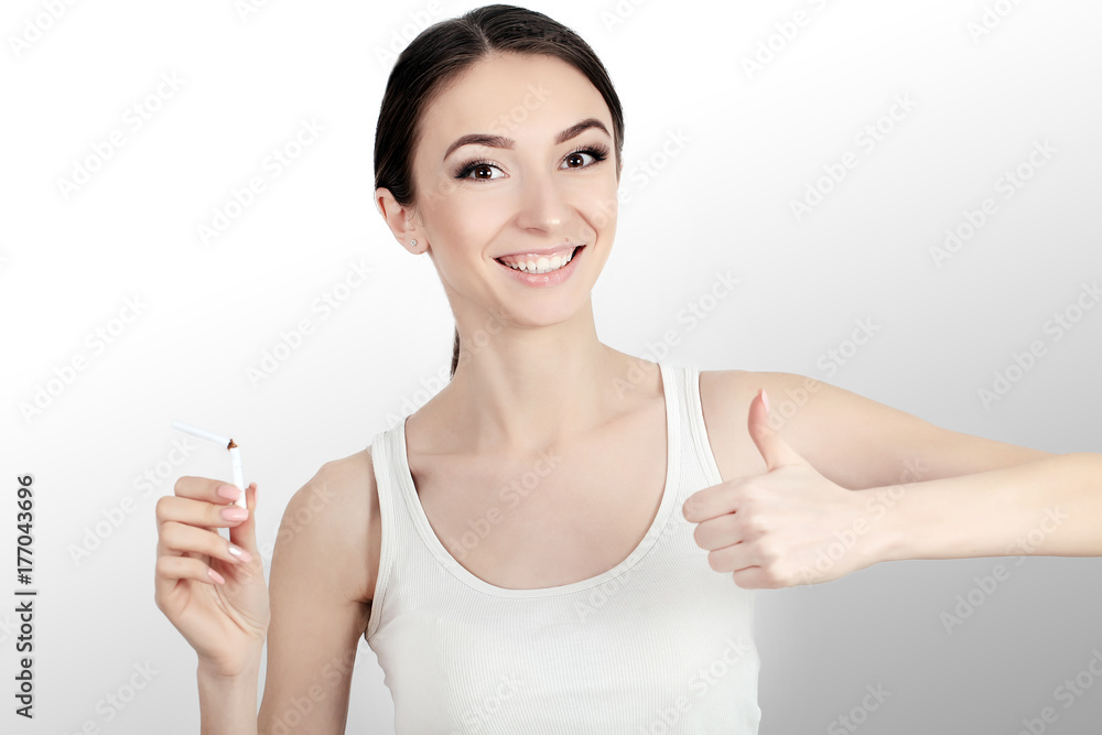 Beautiful Woman Holding Broken Cigarette. Quitting Cigarettes Beautiful Woman Holding Broken Cigarette. Quitting Cigarettes