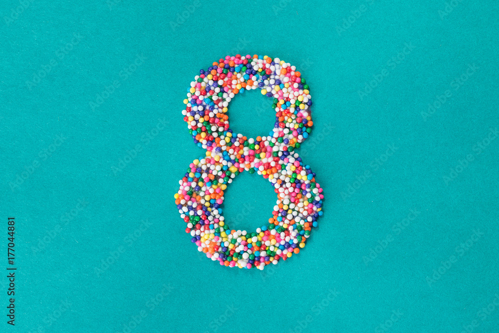 © Kathryn Swayze/Stocksy - The number eight built from nonpareils