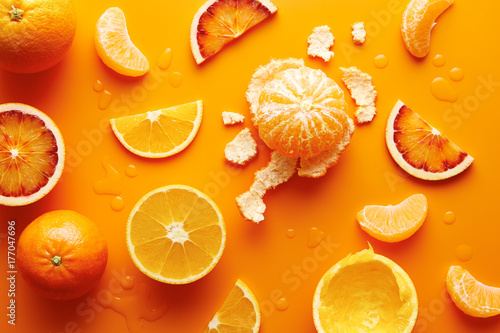 Citrus fruits on orange background photo