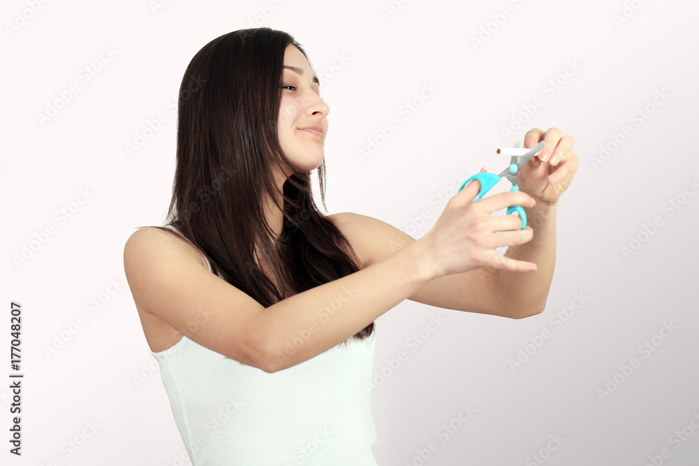 Stop Smoking Cigarettes Concept. Portrait Of Beautiful Smiling Woman Holding Broken Cigarette In Hands. Happy Female Quitting Smoking Cigarettes. Quit Bad Habit Concept. High Resolution Stop Smoking Cigarettes Concept. Portrait Of Beautiful Smiling Woman Holding Broken Cigarette In Hands. Happy Female Quitting Smoking Cigarettes. Quit Bad Habit Concept. High Resolution
