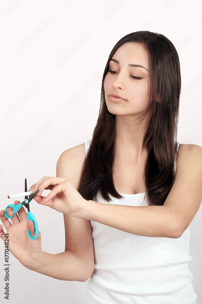Quit Smoking. Closeup Of Beautiful Happy Female Breaking Cigarette. Portrait Of Smiling Woman Holding Broken Cigarette In Hands. Healthy Lifestyle Concept. High Resolution Quit Smoking. Closeup Of Beautiful Happy Female Breaking Cigarette. Portrait Of Smiling Woman Holding Broken Cigarette In Hands. Healthy Lifestyle Concept. High Resolution