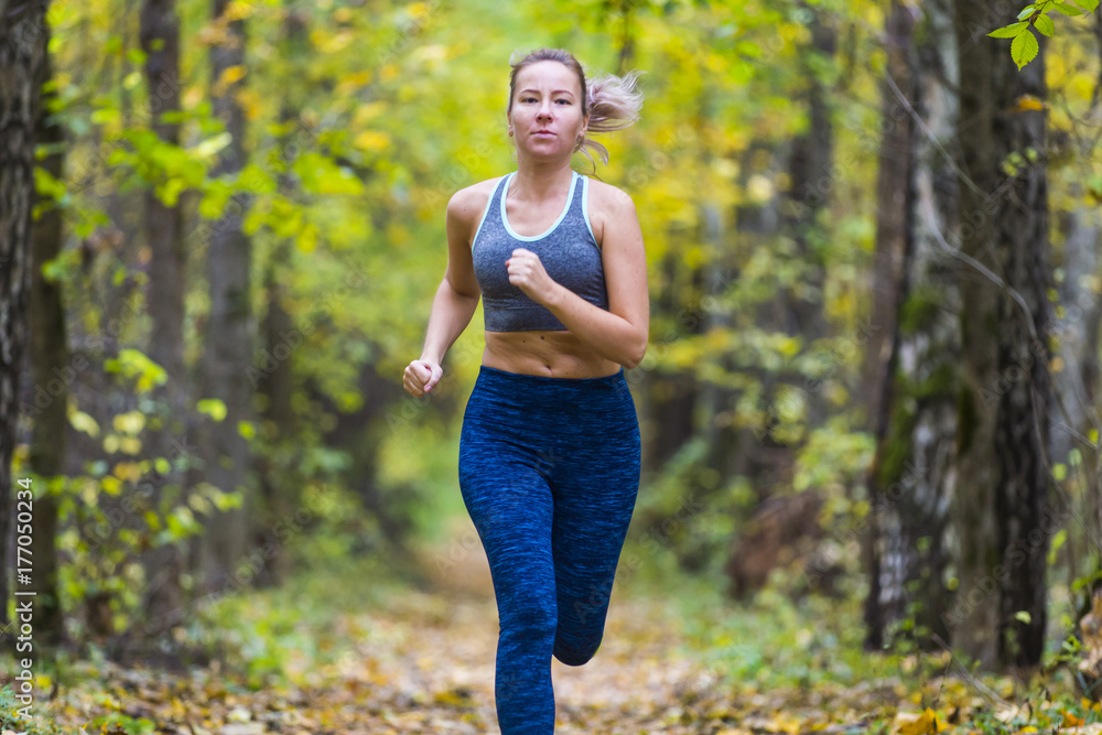 Woman running in the autumn park Woman running in the autumn park
