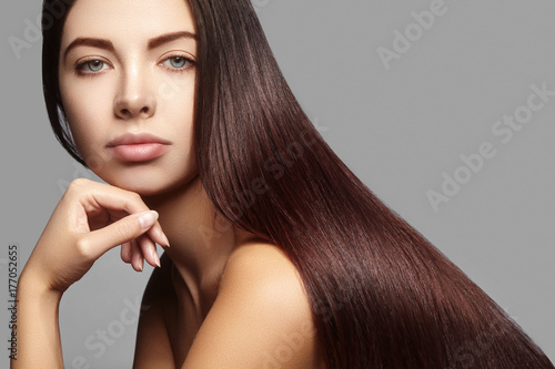 Beautiful yong Woman with Long Straight brown Hair. Sexy Fashion Model with smooth gloss Hairstyle. Keratin treatment