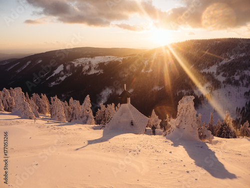 Sunset over the snowy mountains photo