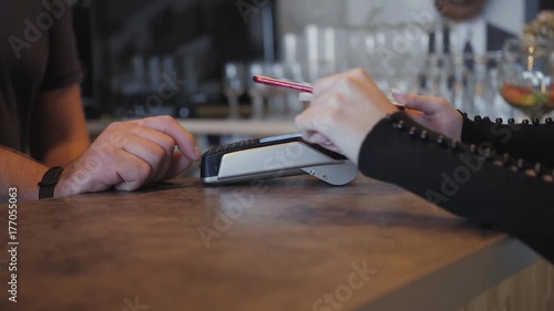 Concept NFC contactless payment. Making payment with mobile phone and pos terminal, printed check.