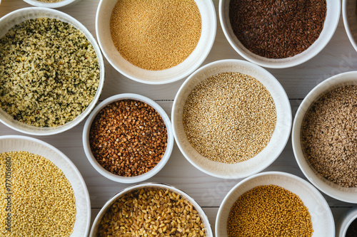 Various health seeds and grains arranged in bowls photo