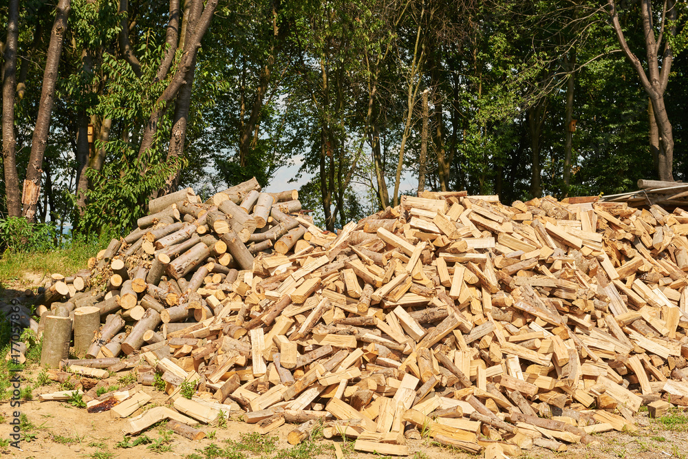 Stacked firewood heap against old weathered Stacked firewood heap against old weathered