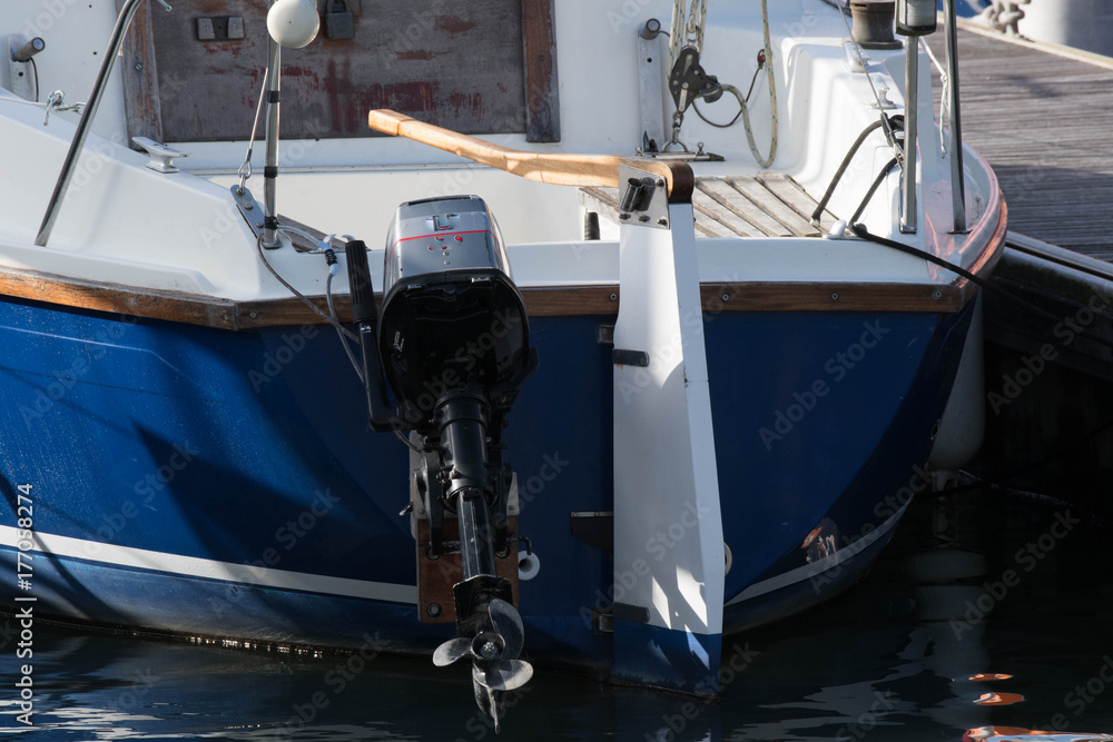 Yacht stern moored with outboard
