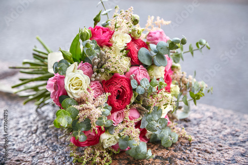 bouquet of the bride on the stone
