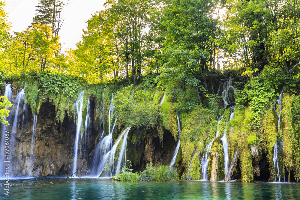 Close up of blue waterfalls in a green forest during daytime in Summer.Plitvice lakes, Croatia