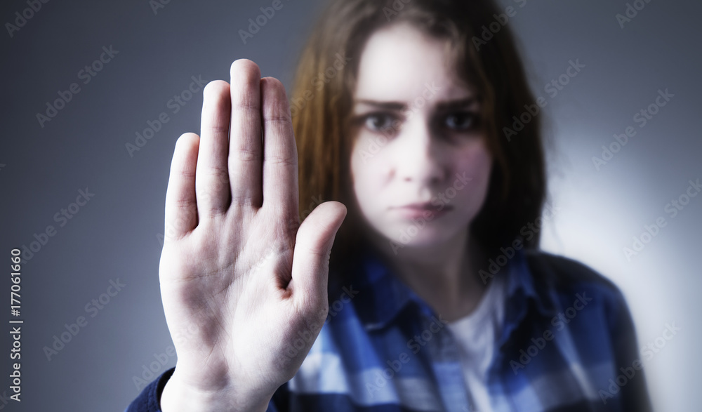 Girl showing stop hand sign gesture (Body language, gestures, psychology) Girl showing stop hand sign gesture (Body language, gestures, psychology)