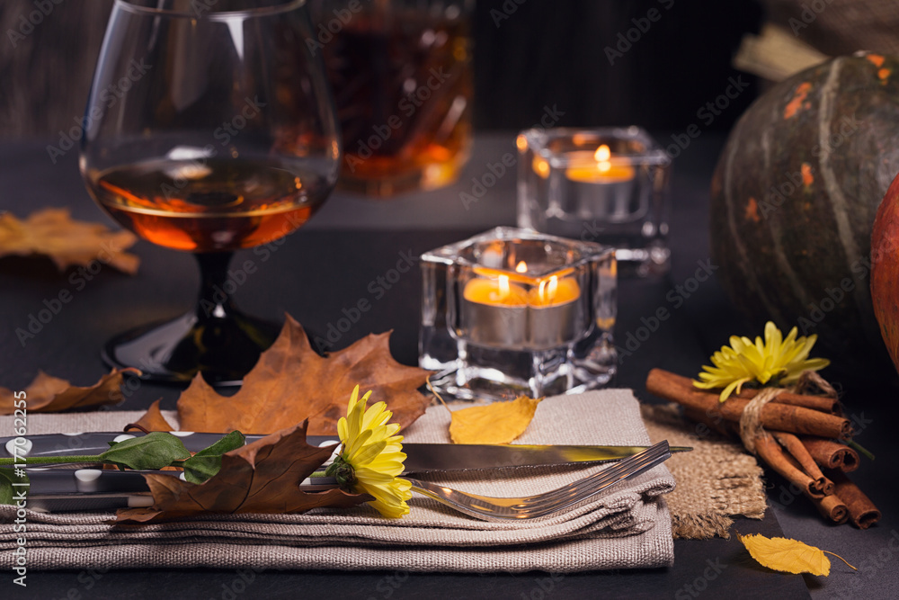 Table setting with autumn decoration for Thanksgiving.