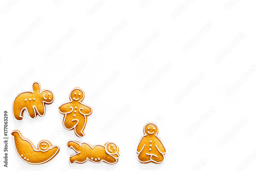Gingerbread cookies in shape of yoga asanas on white background top view copyspace Gingerbread cookies in shape of yoga asanas on white background top view copyspace