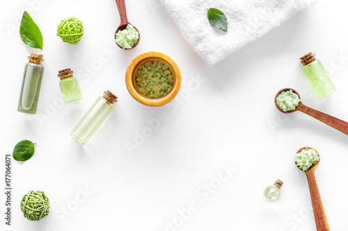 bath salt in herbal cosmetic set with tea olive leaves on white background top view space for text