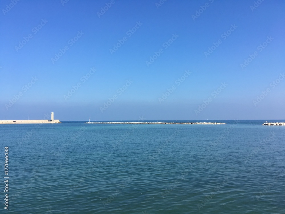 lighthouse at small harbor’s entrance in Bari, Italy