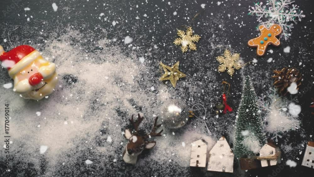 Greeting Season concept.Christmas tree and decorations with presents and ornaments on wood table from above with falling snow in 4k (UHD) Greeting Season concept.Christmas tree and decorations with presents and ornaments on wood table from above with falling snow in 4k (UHD)